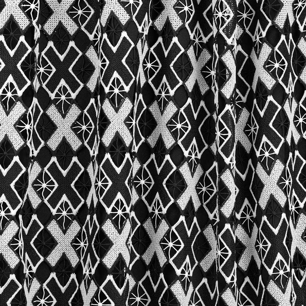 A draped sample of Knockout Mechanical Lace on a black background.