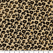 A sample of Cream Leopard Printed Spandex and a ruler for scale. Design includes leopard prints in a neutral background.