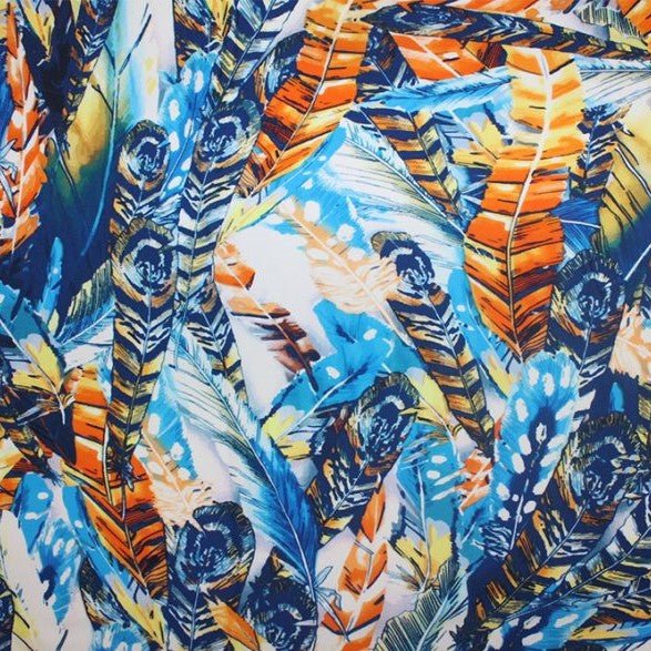 A flat sample of blue feathers printed spandex.