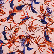 A flat sample of red fan palms printed spandex.
