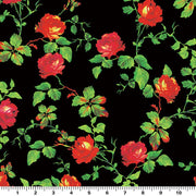 A flat sample of red rose vine on black printed spandex and a ruler for scale.