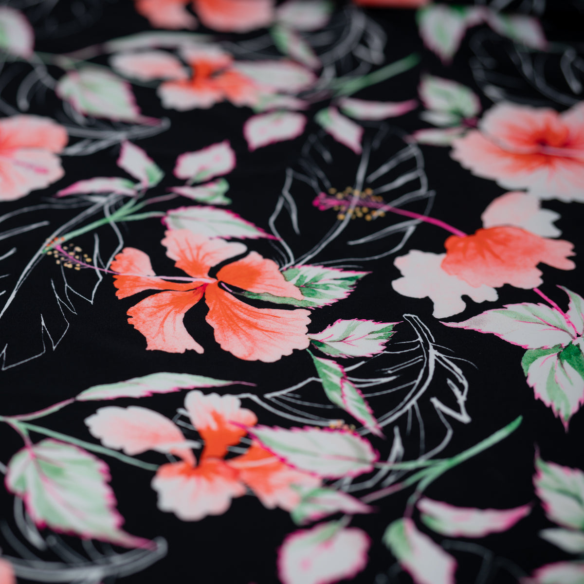 Detailed shot of Hibiscus Flowers on Black Printed Spandex.