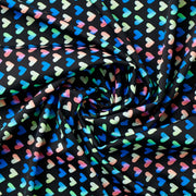 Swirled piece of Rainbow Hearts Printed Spandex.