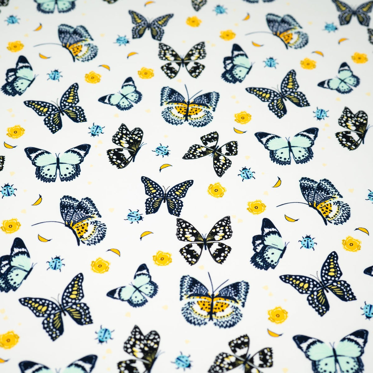 A flat sample of Butterflies and Ladybugs Printed Spandex