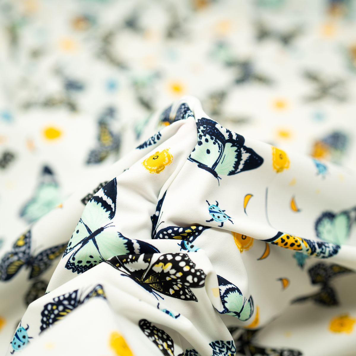 A crumpled piece of Butterflies and Ladybugs Printed Spandex