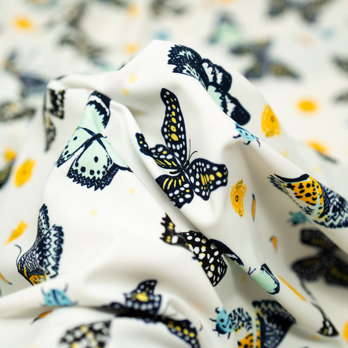 A crumpled piece of Butterflies and Ladybugs Printed Spandex