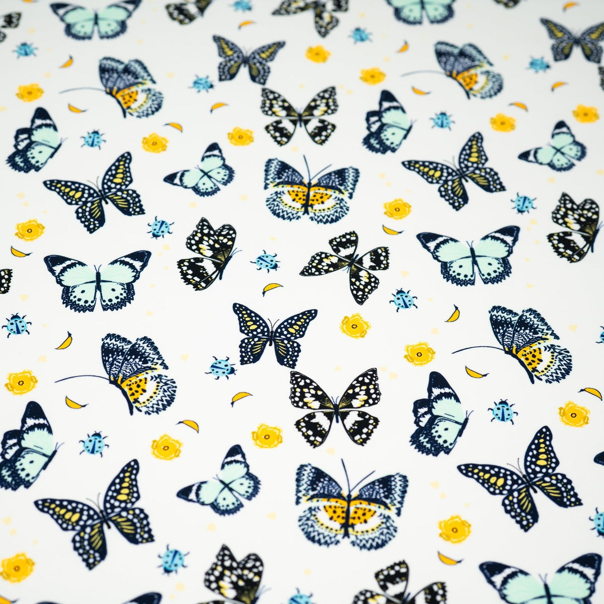 A flat sample of Butterflies and Ladybugs Printed Spandex
