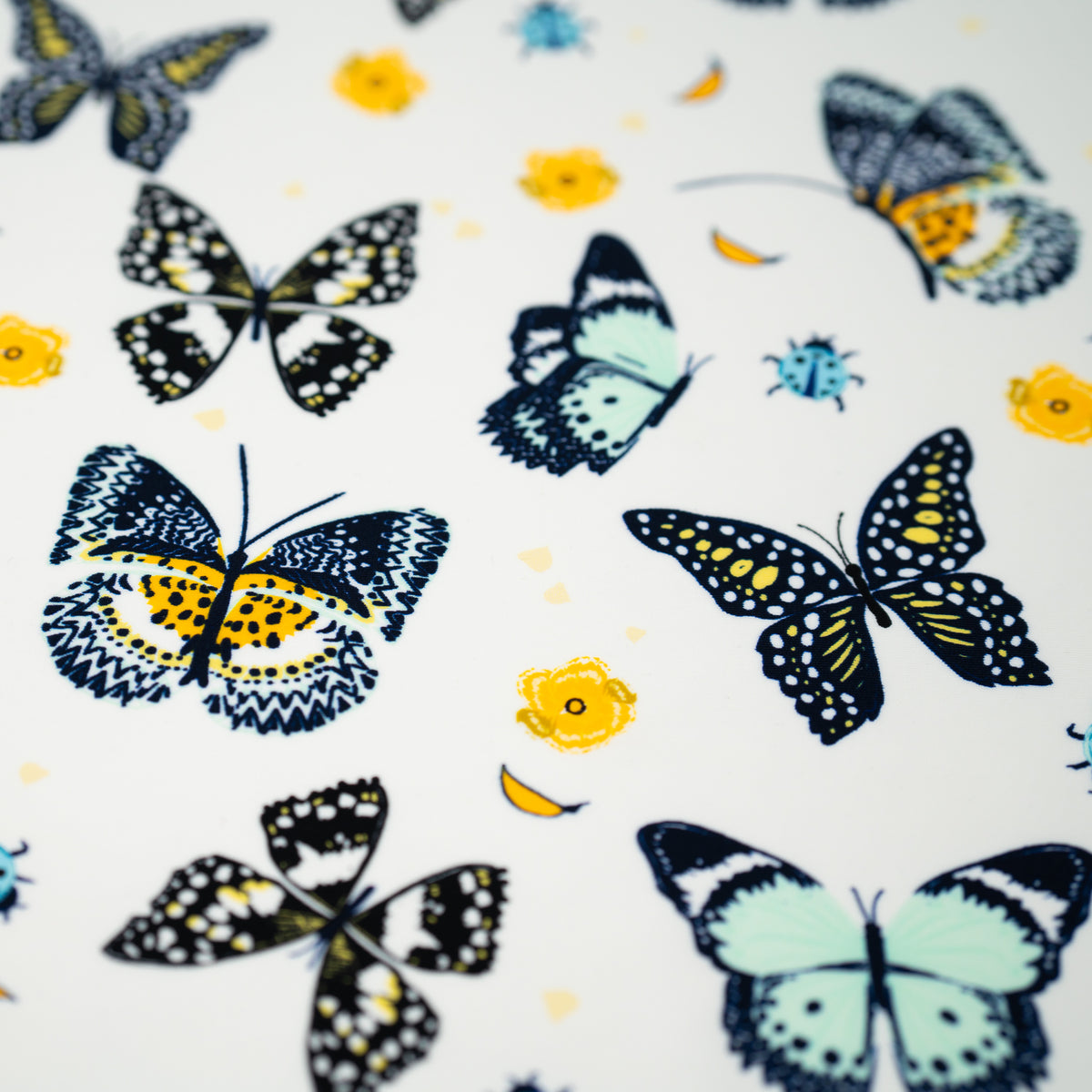 A flat sample of Butterflies and Ladybugs Printed Spandex
