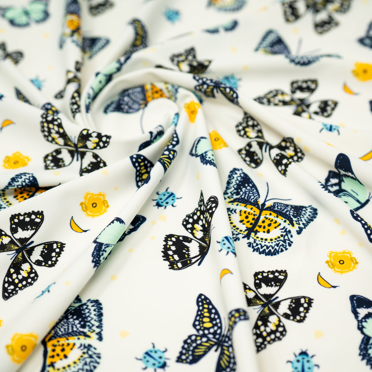 A swirled piece of Butterflies and Ladybugs Printed Spandex