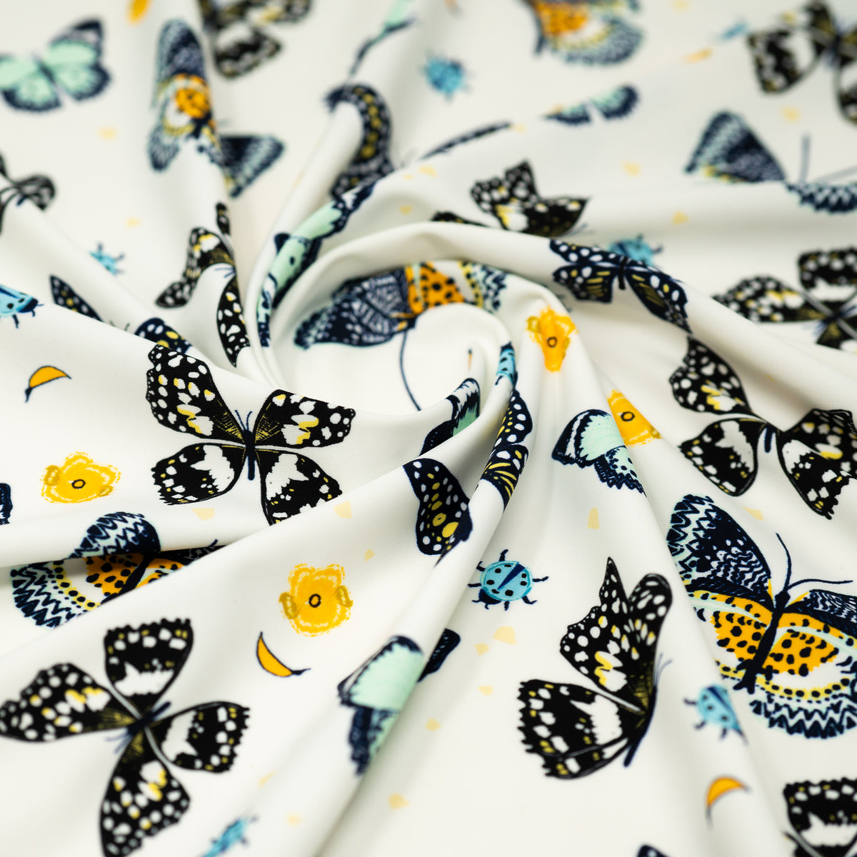 A swirled piece of Butterflies and Ladybugs Printed Spandex