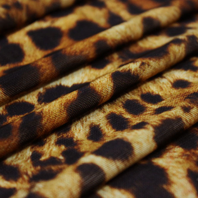 A folded sample of leopard spotted safari printed power mesh.